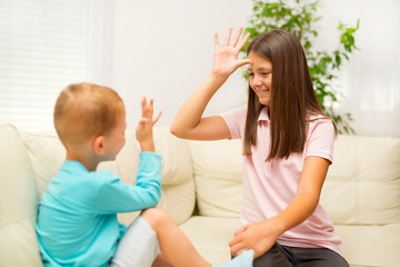Brother and sister learn sign language at home