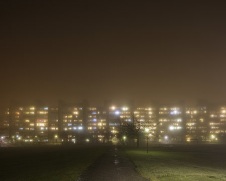 Sweden, Skane, Malmo, Rosengard, Illuminated residential buildings in fog