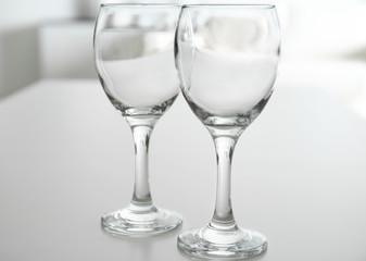 Wineglasses on blurred interior background