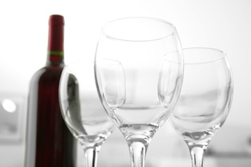 Wineglasses on blurred interior background