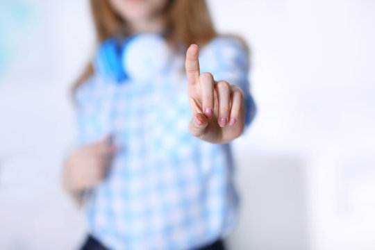Female hand with pointing finger on blurred background