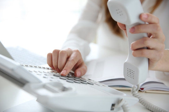 Businesswoman with office IP telephone