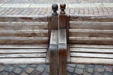 Old bench made of natural wood in the town square