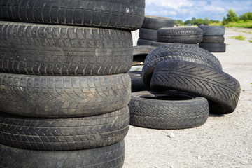 Old erased tires heaped on concrete plates