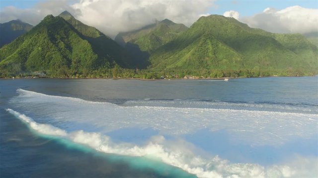 AERIAL: Big Teahupoo wave breaking and rolling towards Tahiti island