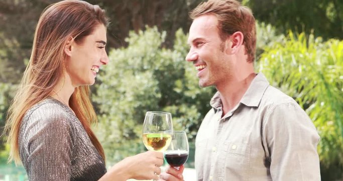 Smiling couple with jealous woman on background poolside