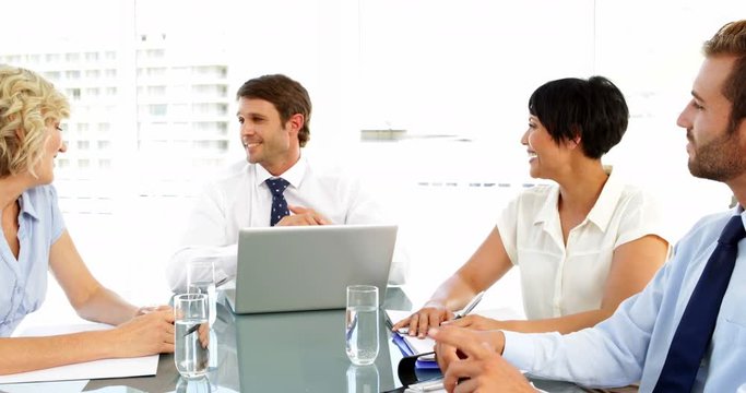 Business people chatting and laughing during a meeting