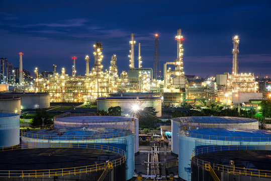 Oil refinery or petroleum refinery and storage tanks in night.