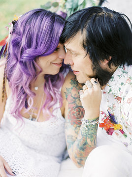 Sweden, Bride with purple hair and groom at hippie wedding