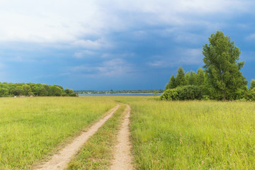 rural landscape with country road, the sky before the storm