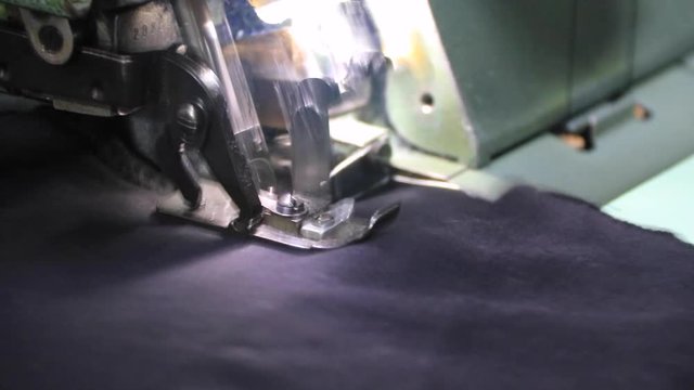 Professional overlock sewing machine with black fabric