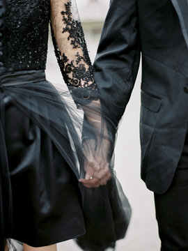 Sweden, Young formally dressed couple holding hands
