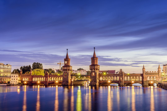 Germany, Berlin, Illuminated Oberbaum Bridge and reflections in river