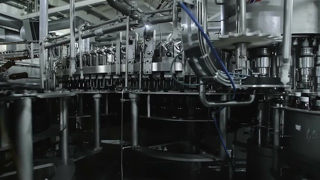 Conveyor Putting The Lids On Plastic Bottles