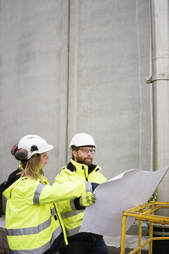 Sweden, Vastmanland, Man and woman discussing blueprints