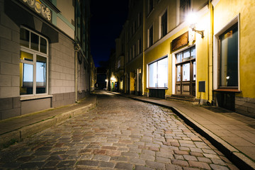 A cobblestone street at night, in Tallinn, Estonia.