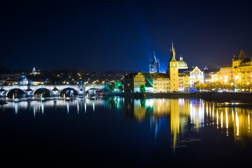 Fototapeta na wymiar Charles Bridge and buildings along the Vltava at night, in Pragu