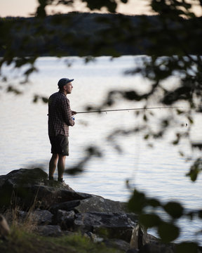 Sweden, Skane, Immeln, Mid adult man fishing
