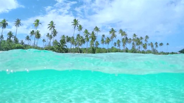 SLOW MOTION UNDERWATER: Amazing tropical island and turquoise ocean lagoon