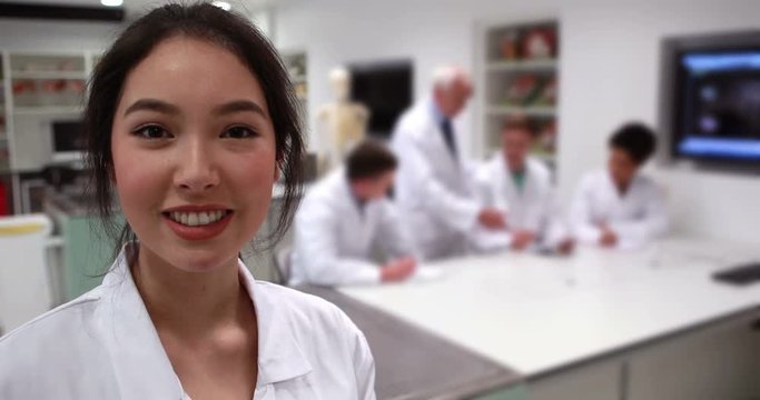 Pretty medical student smiling at camera in class
