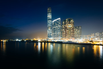 Fototapeta na wymiar Skyscrapers in Kowloon at night, seen from Tsim Sha Tsui, in Kow