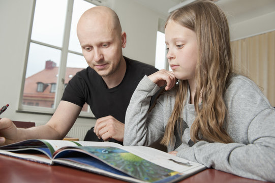 Sweden, Teacher explaining book to student (8-9)