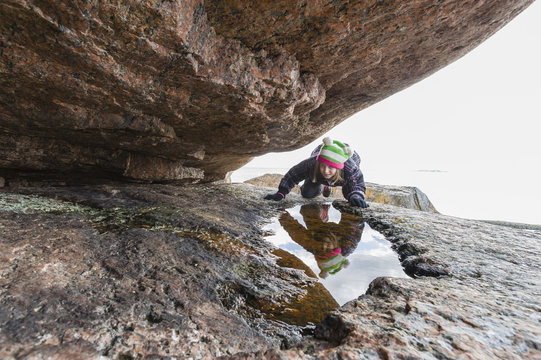 Girl climbing on rock outdoors