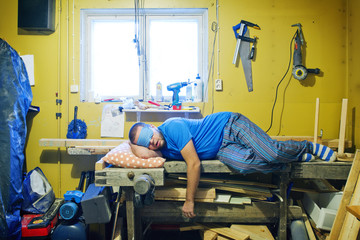 Man sleeping on workshop's table