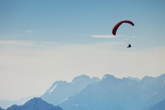 Austria, Tyrol, Paraglider flying over mountains