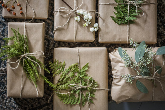 Overhead view of wrapped Christmas presents with plants