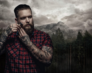 Shaving brutal tattooed male.