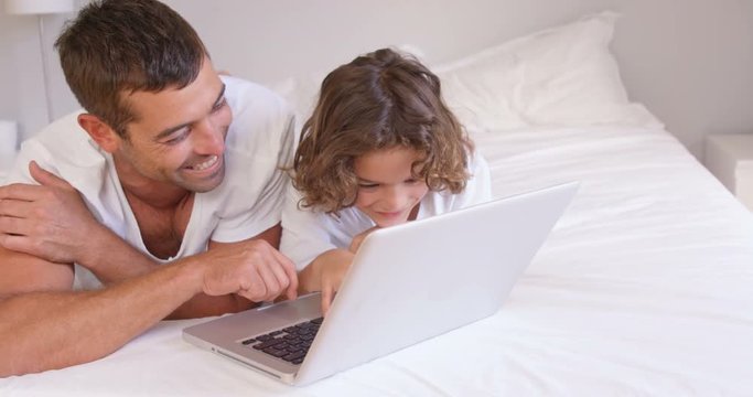 Father and son using laptop