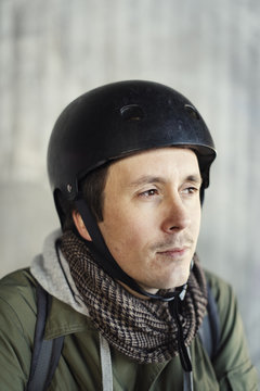 Sweden, Sodermanland, Stockholm, Sodermalm, Slussen, Mid adult man in helmet looking away