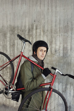 Portrait of man holding bicycle outdoors