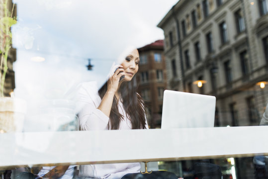 Sweden, Uppland, Stockholm, Woman talking on phone