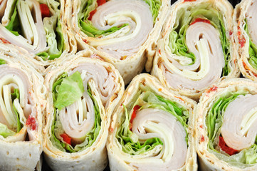 tortilla deli wrap rolls with ham vegetable isolated on white background