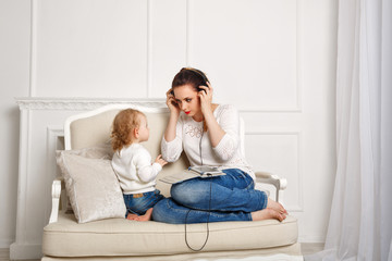 Obraz premium Mother and little daughter. Listen to music