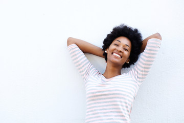 Carefree woman leaning back with hands behind head