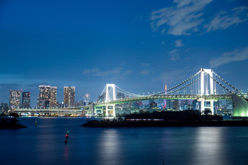 Fototapeta na wymiar Tokyo city and rainbow bridge at twilight