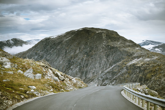 Norway, More og Romsdal, Sunnmore, View down curving roan with mountain in background