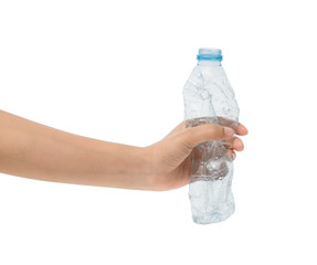 Crushed empty plastic bottle in woman's hand