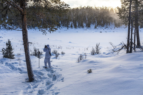 Sweden, Vasterbotten, Tarnaby, Goose hunter (16-17) in winter forest