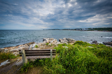 Bench and view of rocky coast in Rye, New Hampshire.