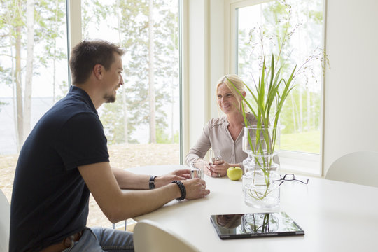 Sweden, Man and woman sitting and drinking at home