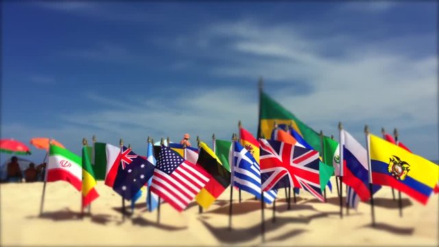 International flags flying in bright sun on Ipanema Beach in Rio de Janeiro, Brazil