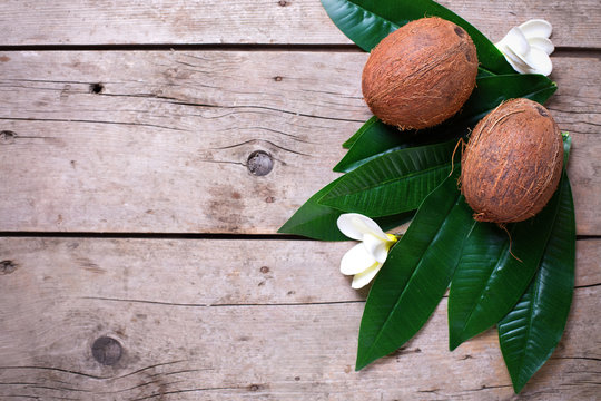 Coconuts on wooden background.