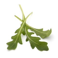 Sweet rucola salad or rocket lettuce leaves isolated on white ba