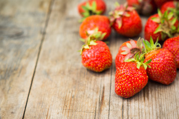Ripe strawberries on the wooden table. Shallow depth fo field.