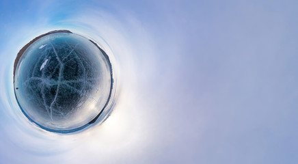 Blue ice of Lake Baikal covered with cracks, cloudy weather at s