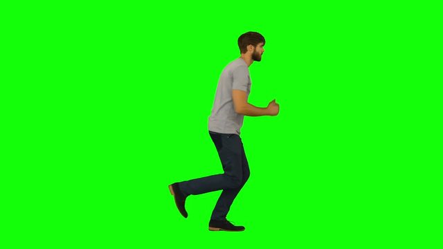 Casual man running on green screen background